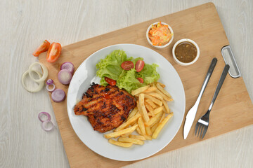 delicious plate of western food chicken chop with fries and salad
