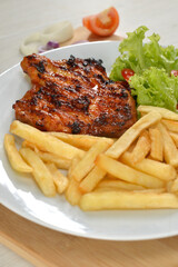 delicious plate of western food chicken chop with fries and salad