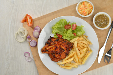 delicious plate of western food chicken chop with fries and salad