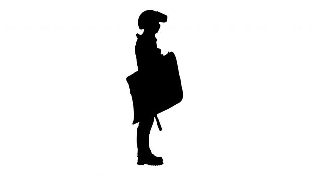 Silhouette Special unit riot policeman with a shield and baton standing waiting.
