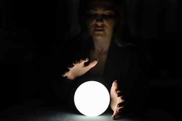 A fortune teller gazes into her ball