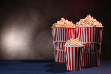 Delicious popcorn on blue wooden table. Space for text