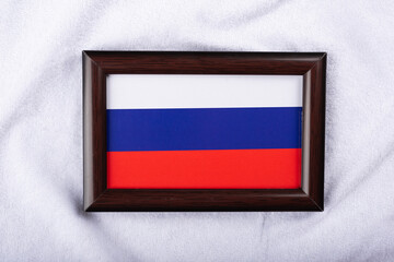 Russia flag in a realistic frame on white cloth background flat lay photo