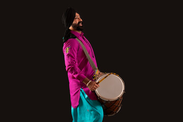 A man in Bhangra costume singing along with beating the dhol.	 - obrazy, fototapety, plakaty