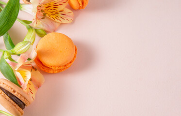 Obraz na płótnie Canvas macaroons, beige, peach, French cookies with flowers on a beige background,