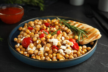 Delicious fresh chickpea salad on black table