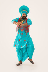 A Bhangra Dancer performing with Khunda.	