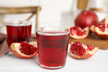Pomegranate juice and fresh fruits on white wooden table