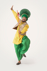 A Bhangra Dancer performing with a Kato.	