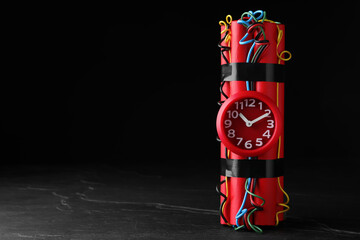 Explosive dynamite time bomb on black background. Space for text