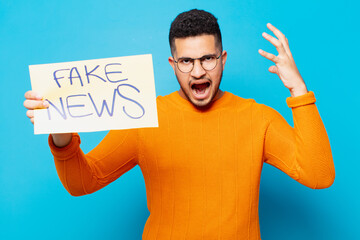 young hispanic man angry expression fake news concept
