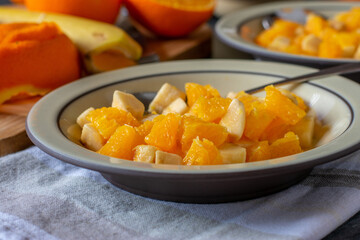 Chopped oranges and bananas for healthy dessert or snack on a plate