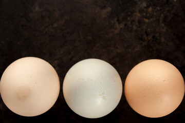Thrre colorful eggs on black background