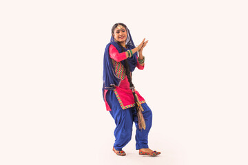 A Giddha Dancer performing a dance step.	