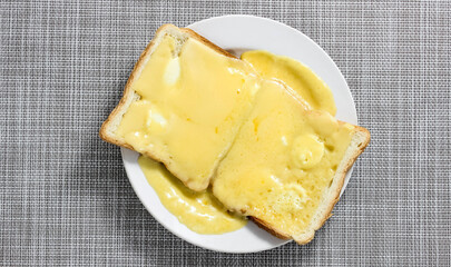 A plate of sandwiches with melted cheese and spices.