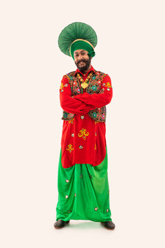 A Bhangra Dancer Standing With His Hands Folded.	