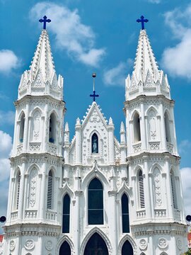Basilica of Our Lady of Good Health, Sanctuary of St. Mary's shrine, Cathedral of St. Mary, facade of holy trinity. Roman Catholic Latin church tower against blue sky background in Velankanni.