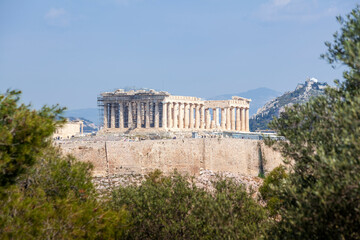 Fototapeta na wymiar Parthenon view from Filopappou Hill. There can be seen the facade and the southern side of the Parthenon temple, of 5th century BC, on the sacred Akropolis Hill, in Athens, Greece, Europe