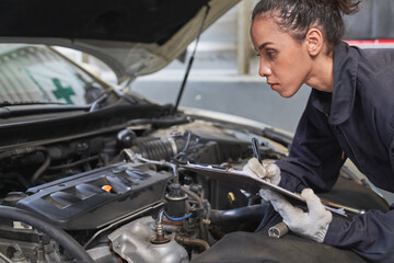 Fototapeta na wymiar Technician female check list for maintainance a in car garage service