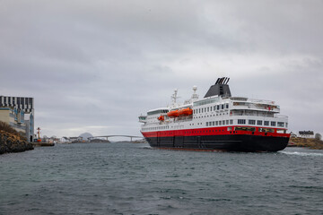 Fototapeta na wymiar Coastal liner arrives in Bronnoysund harbor ,Helgeland,Nordland county,Norway,scandinavia,Europe