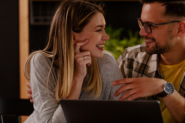 Smile couple is talking with their family on computer. Online meeting. Close up.