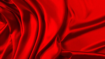 Red silk or satin luxury fabric texture can use as abstract background. Top view.