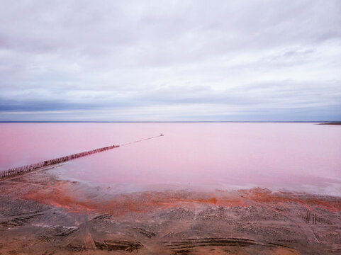 Aerial view of red salt lake. Deserted shoreline without people. Nobody around