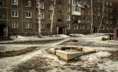 Courtyard of a residential building. Apartment building. Spring. Dirt. Dark urban landscape. Slush. Ust-Kamenogorsk (kazakhstan)