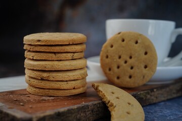Homemade Indian Atta biscuits - Whole wheat cumin  cookies served with tea, selective focus
