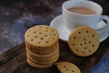 Homemade Indian Atta biscuits - Whole wheat cumin  cookies served with tea, selective focus