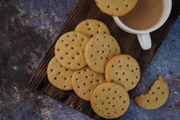 Homemade Indian Atta biscuits - Whole wheat cookies served with tea, selective focus
