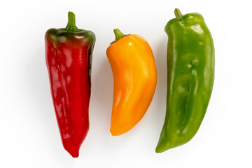 three pointy peppers, red, yellow and green peppers isolated on white