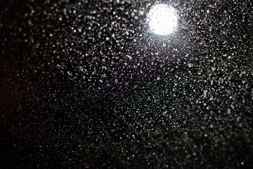 Blurred background with raindrops and lights.