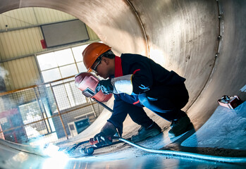 Asian workers are welding steel