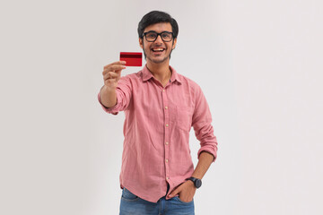 A young man showing his credit card.	