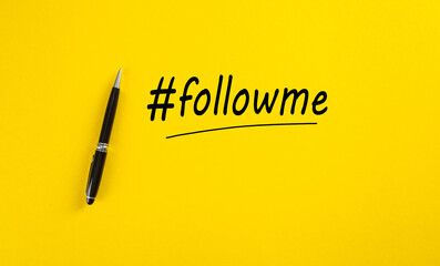 The word follow me or hashtag followme hand written with a black marker pen on yellow background. - obrazy, fototapety, plakaty