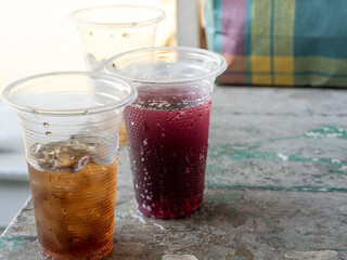Soft drink and ice in the disposable plastic glasses