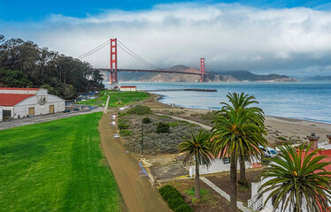 Aerial view of the Golden Gate Bridge from Presidio, against the backdrop of beautiful palm trees...