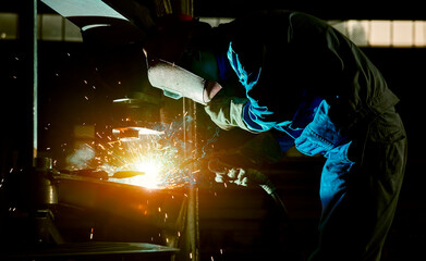 The sparks flew as the worker was welding steel
