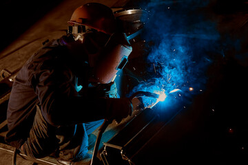 The sparks flew as the worker was welding steel