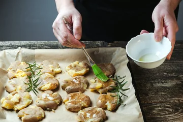 Foto op Canvas Homemade organic food. Roasted potatoes with rosemary. Chef preparing healthy vegan food. © volurol