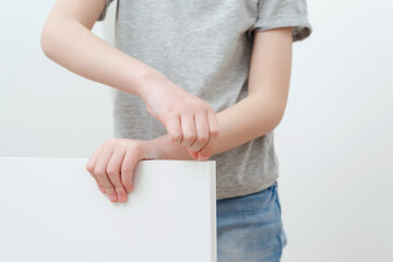 Boy assembles a bookshelf hisself. Dad and little son assembling furniture at home.