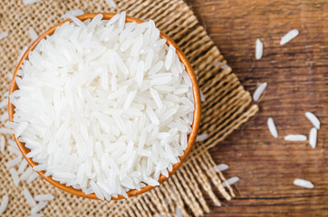 Organic Thai Jasmine rice grain in wooden bowl.