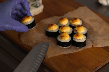 Baked rolls on baking paper on a cutting board