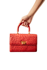 Hand holding a red ostrich leather female bag on white background