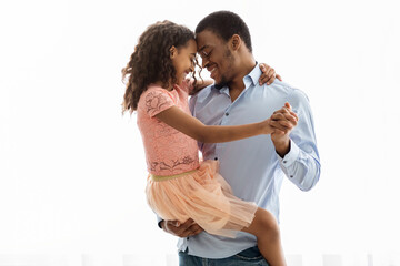 Cute black father and daughter dancing over white - obrazy, fototapety, plakaty
