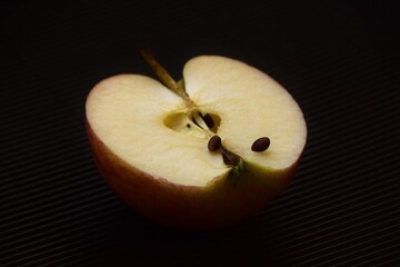 half an apple on a black background