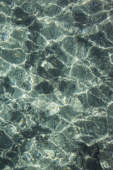 Water flowing with many reflexes and a nice transparent color