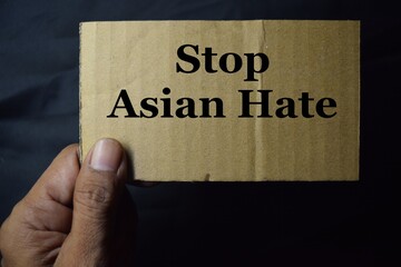 Stop Asian Hate Concept. Campaign, Protest or Expression Concept.  Person Raised a Cardboard with Text.