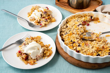 Two plate with apple and pear crumble with ice cream, streusel. Sweet dessert with stewed fruit...